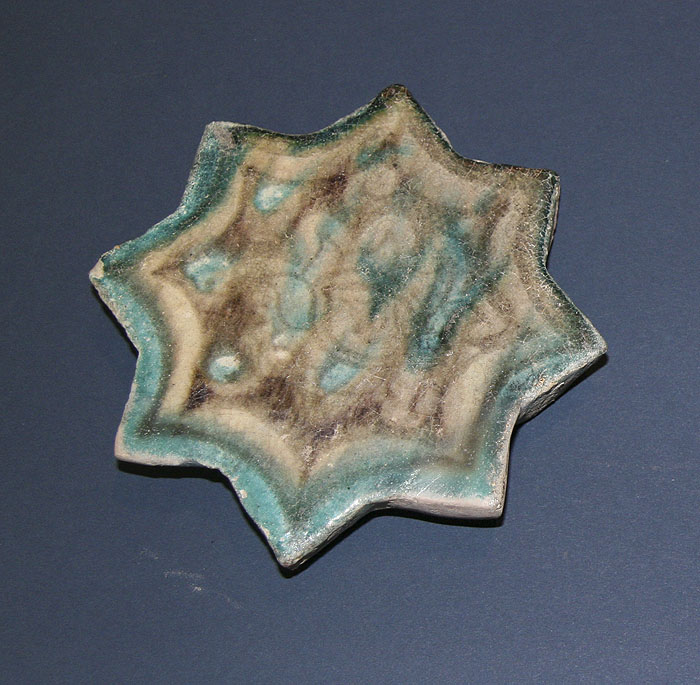  A Syrian Glazed Pottery Star Tile